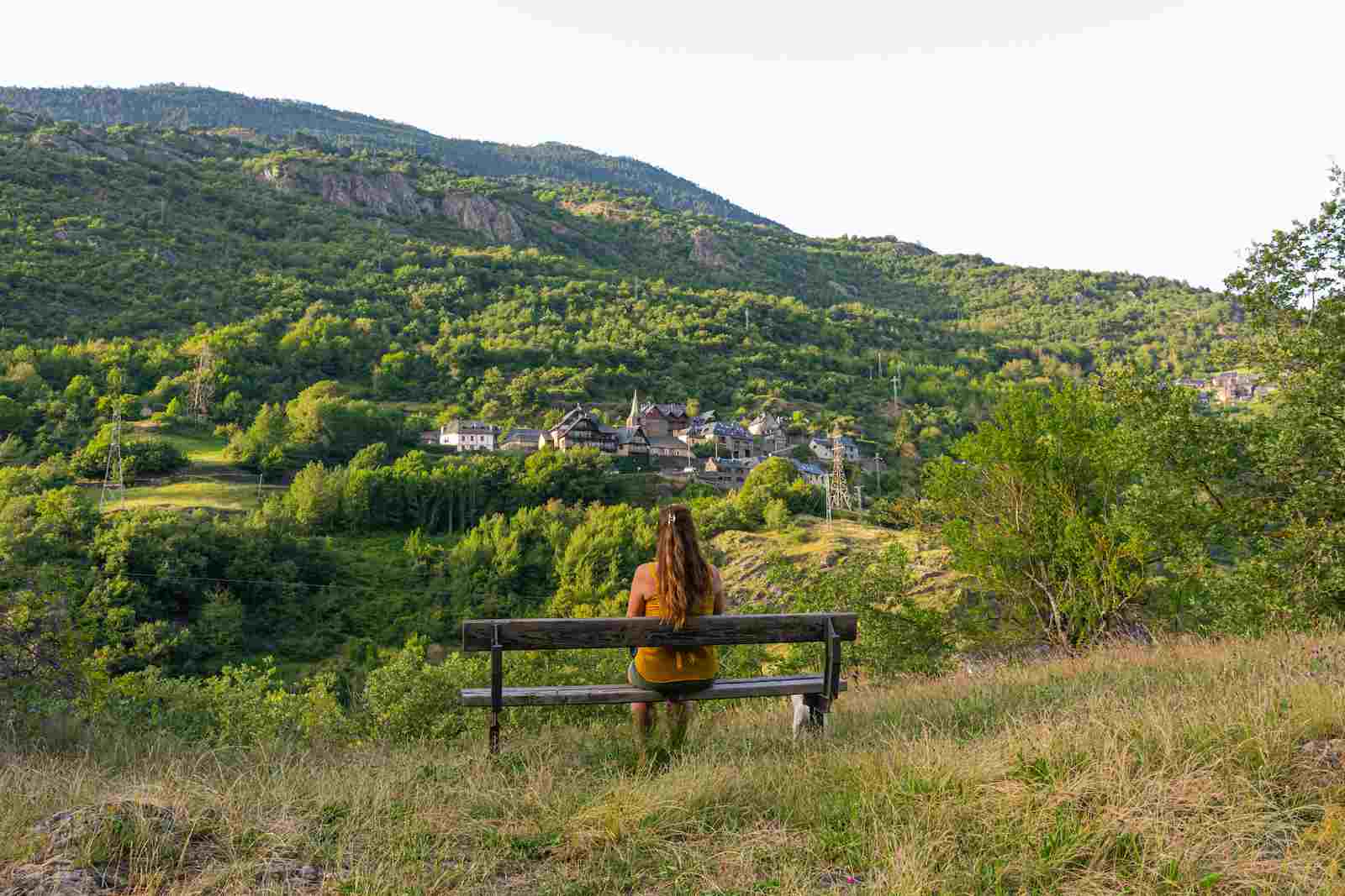 beautiful-shot-woman-sitting-bench-facing-mountain-landscape (1).jpg
