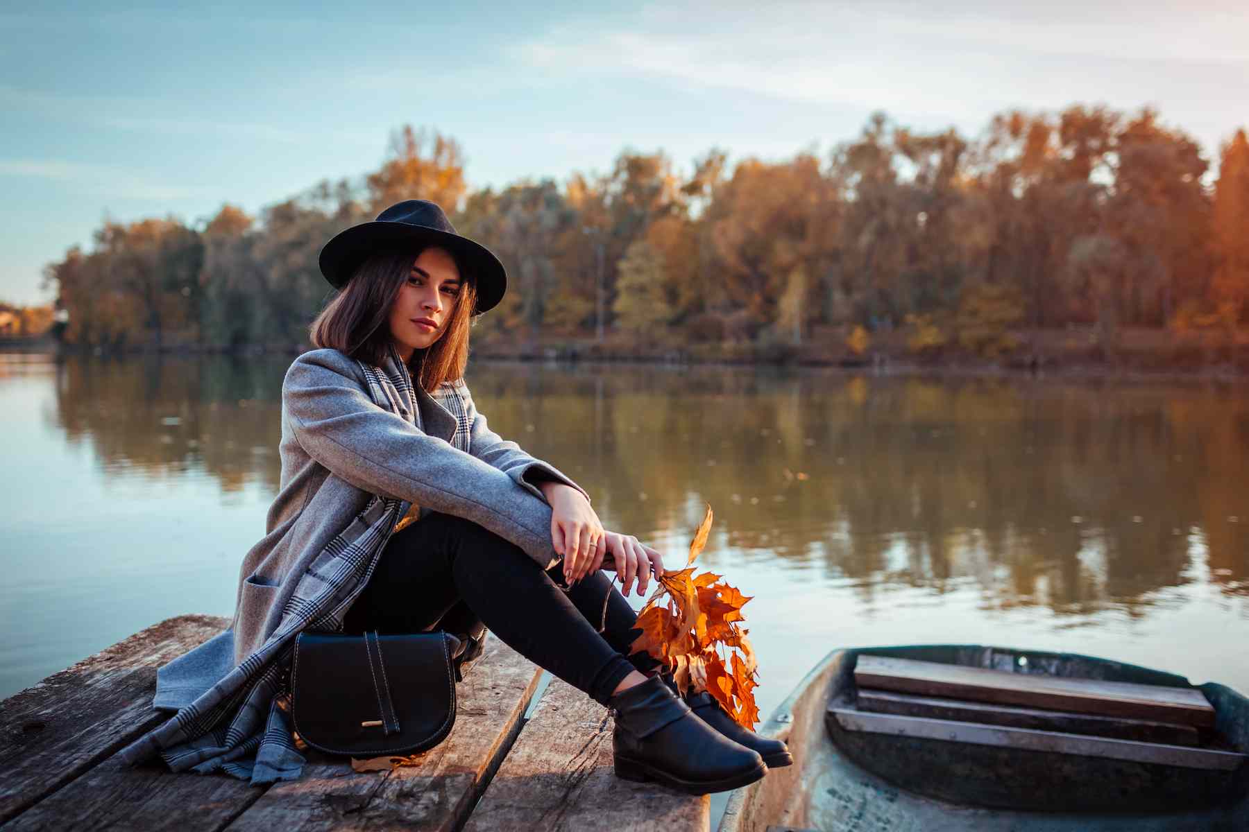 woman-sitting-lake-pier-by-boat-admiring-autumn-landscape-fall-season-activities (1).jpg